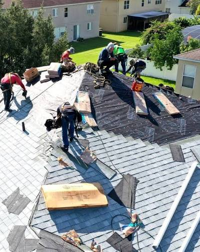 Roofing crew repairing a shingle roof